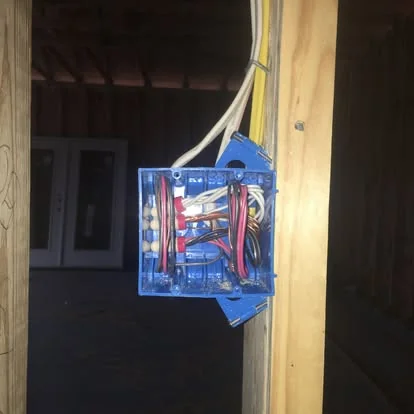 DFS Electric new construction wiring rough-in, blue outlet box on framed wall, Northwest Florida